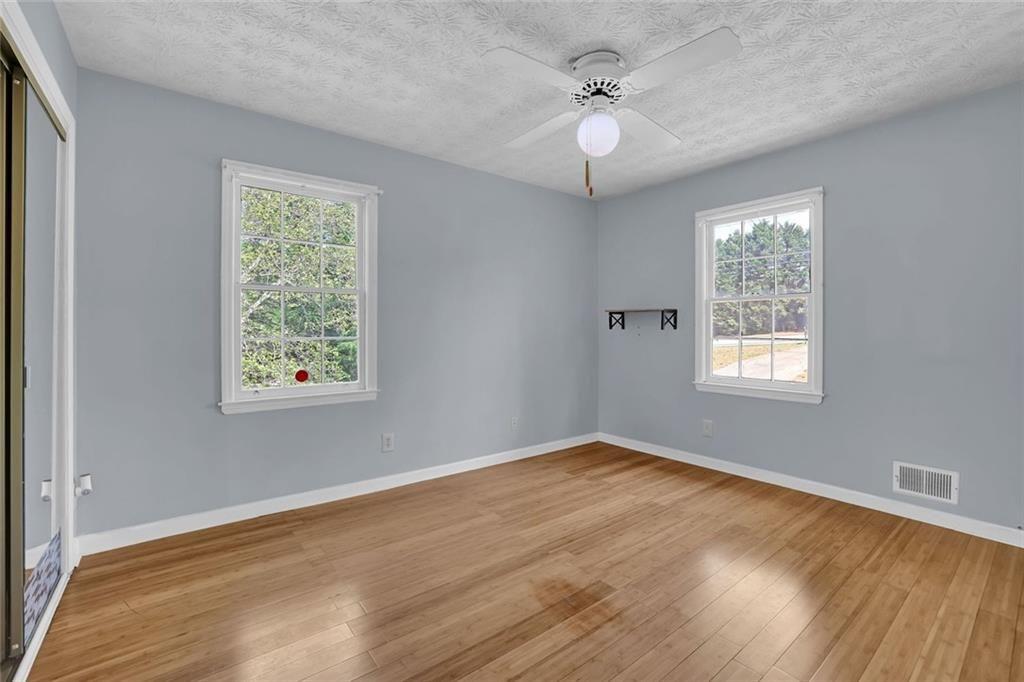 4341 Five Forks Trickum Road Southwest Lilburn, GA 30047 - Photo 11 of 35 a view of an empty room with chandelier fan and a window