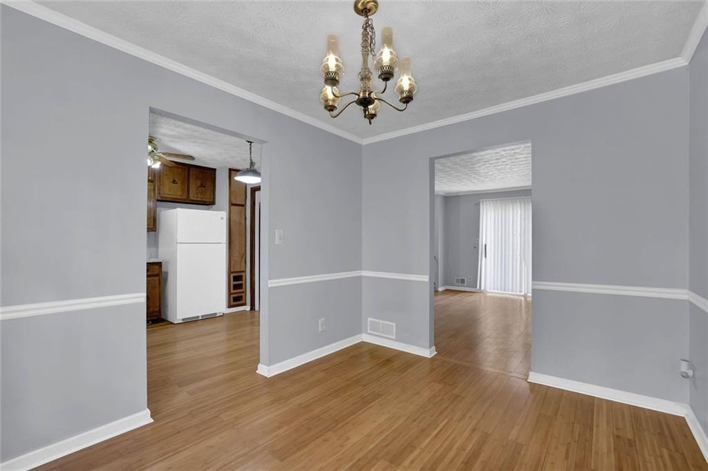 4341 Five Forks Trickum Road Southwest Lilburn, GA 30047 - Photo 16 of 35 wooden floor in an empty room with a window