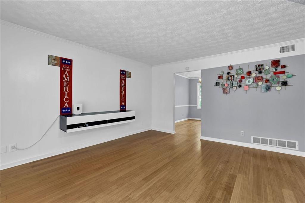 4341 Five Forks Trickum Road Southwest Lilburn, GA 30047 - Photo 20 of 35 a view of an empty room with window and wooden floor