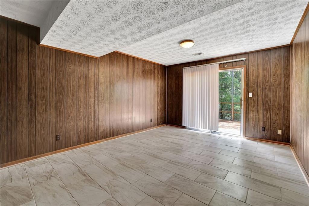 4341 Five Forks Trickum Road Southwest Lilburn, GA 30047 - Photo 24 of 35 en empty room with windows and closet area
