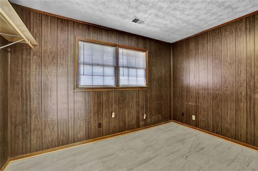 4341 Five Forks Trickum Road Southwest Lilburn, GA 30047 - Photo 25 of 35 an empty room with windows