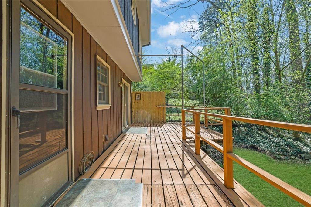 4341 Five Forks Trickum Road Southwest Lilburn, GA 30047 - Photo 28 of 35 a view of balcony with wooden floor and fence