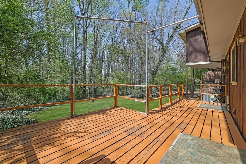 4341 Five Forks Trickum Road Southwest Lilburn, GA 30047 - Photo 29 of 35 a view of a balcony with wooden floor and fence