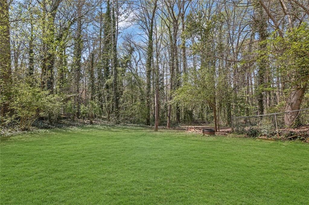 4341 Five Forks Trickum Road Southwest Lilburn, GA 30047 - Photo 30 of 35 a backyard of apartments with large trees