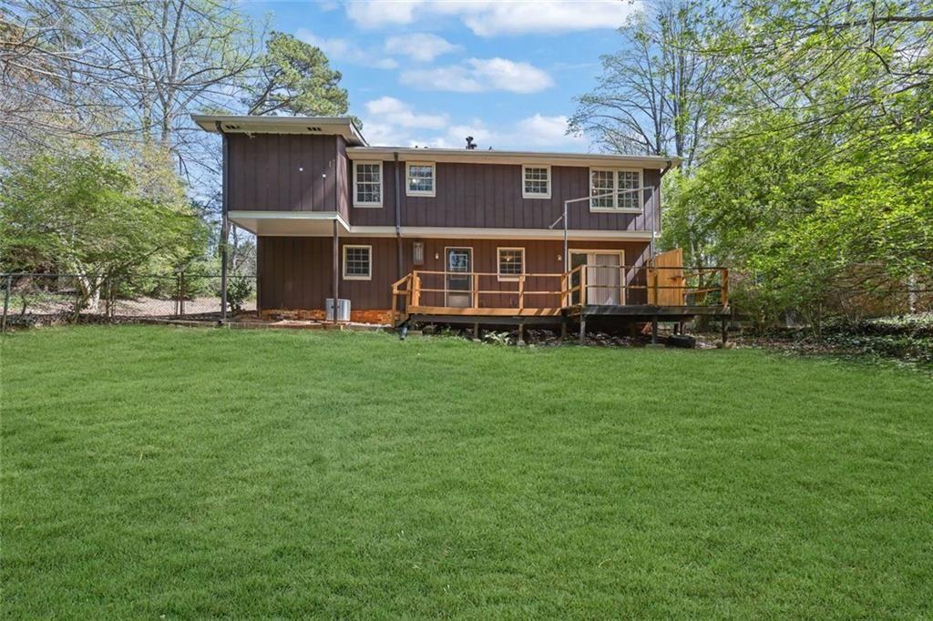 4341 Five Forks Trickum Road Southwest Lilburn, GA 30047 - Photo 32 of 35 a view of a house with a yard