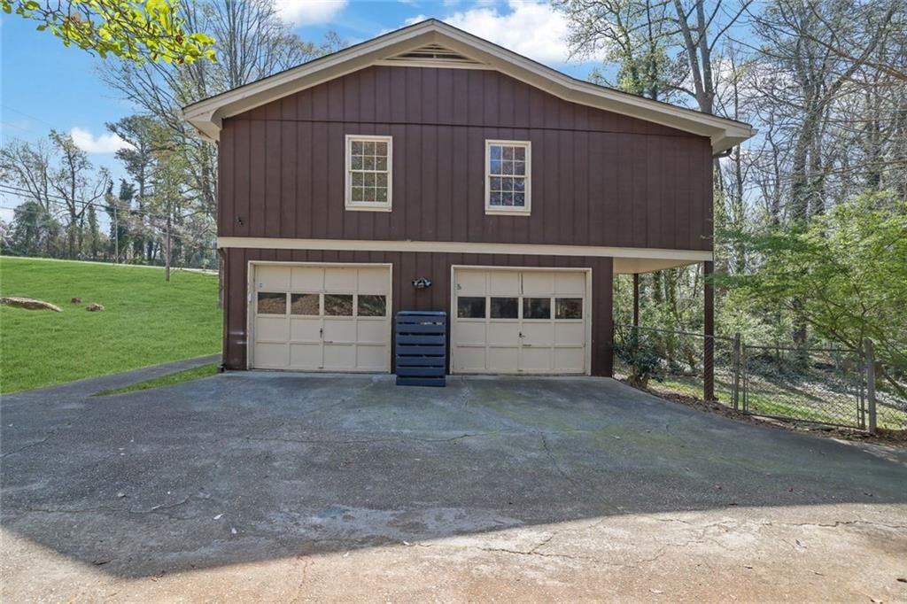 4341 Five Forks Trickum Road Southwest Lilburn, GA 30047 - Photo 33 of 35 a front view of a house with a garden