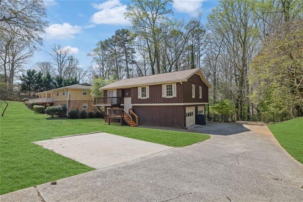 4341 Five Forks Trickum Road Southwest Lilburn, GA 30047 - Photo 34 of 35 a view of a house with a yard and large trees