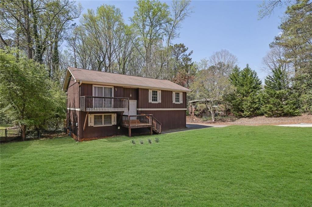 4341 Five Forks Trickum Road Southwest Lilburn, GA 30047 - Photo 35 of 35 a view of a house with a yard
