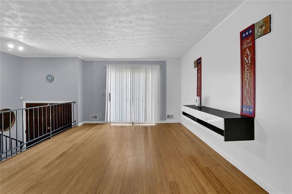 4341 Five Forks Trickum Road Southwest Lilburn, GA 30047 - Photo 4 of 35 a view of an empty room with wooden floor