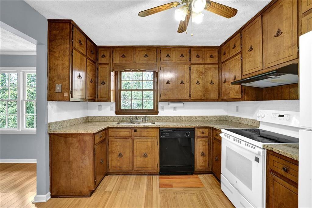 4341 Five Forks Trickum Road Southwest Lilburn, GA 30047 - Photo 6 of 35 a kitchen with a sink stove and cabinets