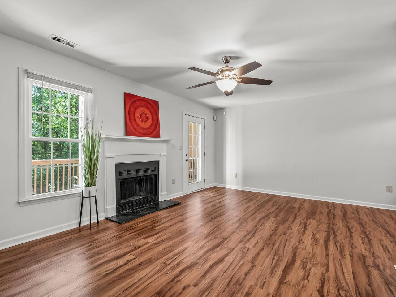 118 Shady Spring Place Durham, NC 27713 - Photo 13 of 33 a view of an empty room with wooden floor and a window