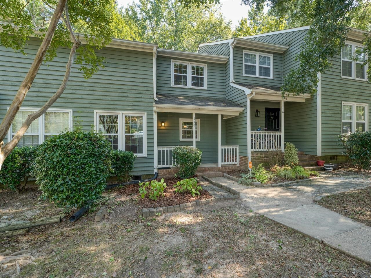 118 Shady Spring Place Durham, NC 27713 - Photo 2 of 33 a front view of a house with garden and plants