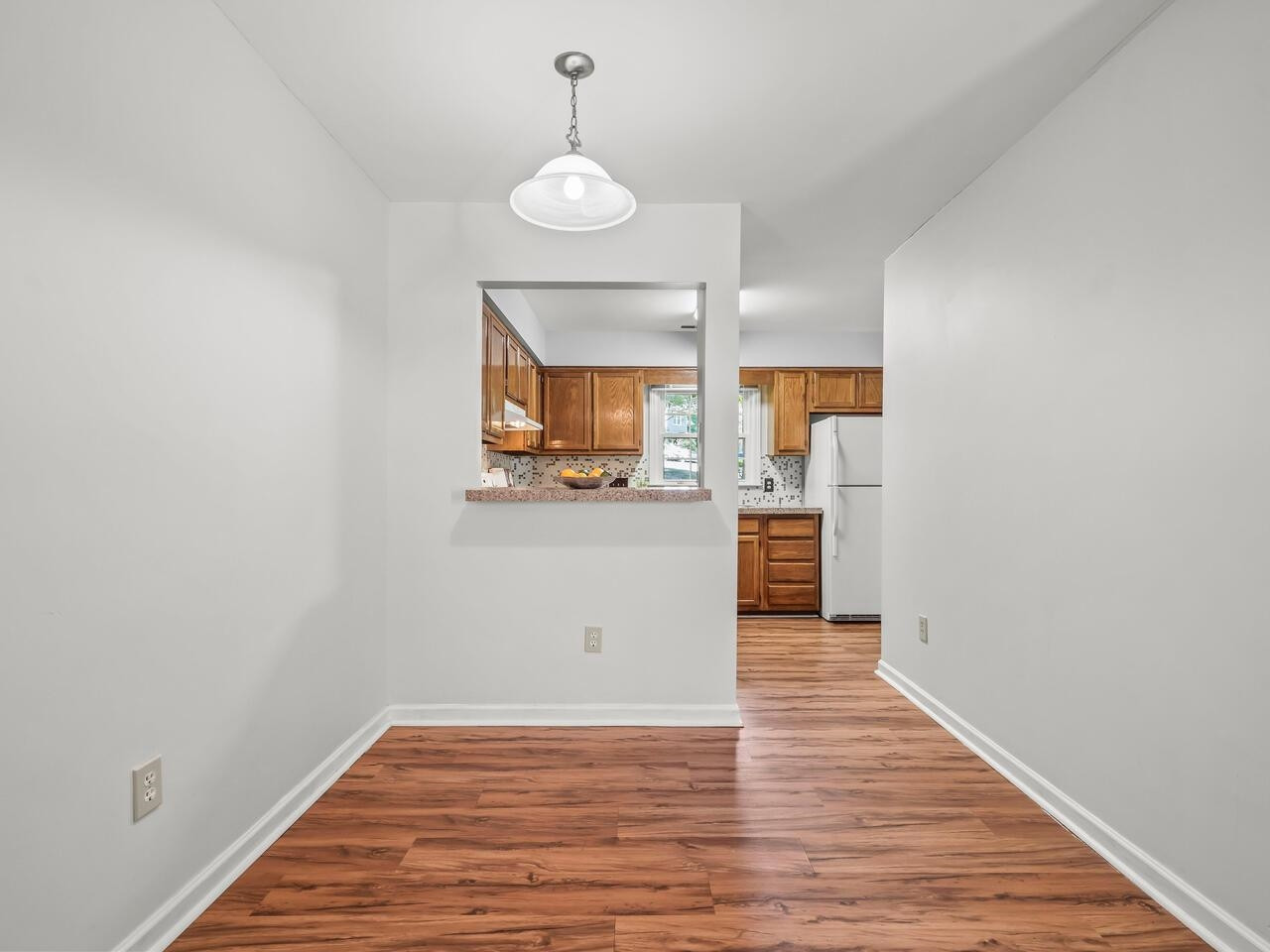 118 Shady Spring Place Durham, NC 27713 - Photo 8 of 33 a view of a kitchen with a sink and dishwasher with wooden floor