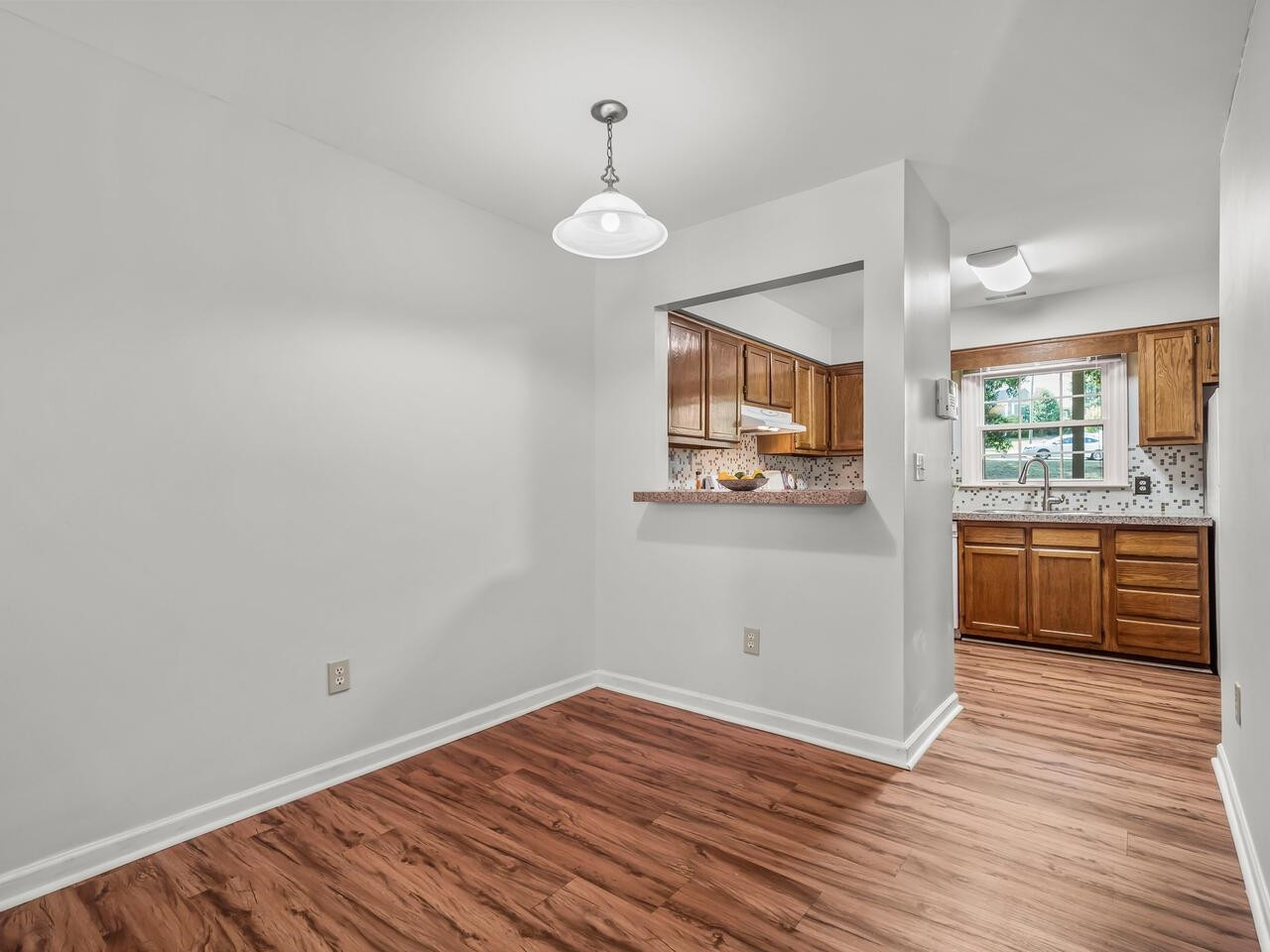 118 Shady Spring Place Durham, NC 27713 - Photo 9 of 33 a view of a kitchen with a sink and dishwasher with wooden floor
