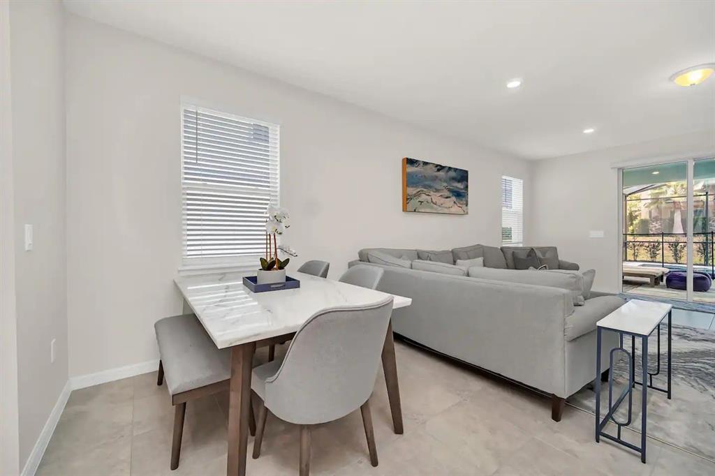 7263 Oakmoss Loop Davenport, FL 33837 - Photo 12 of 57 a view of a dining room with furniture and window