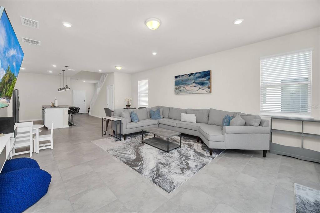 7263 Oakmoss Loop Davenport, FL 33837 - Photo 14 of 57 a living room with furniture a large window and white walls