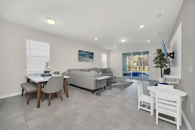 a living room with furniture potted plant and a window