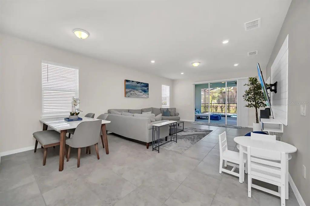 7263 Oakmoss Loop Davenport, FL 33837 - Photo 15 of 57 a living room with furniture and a large window