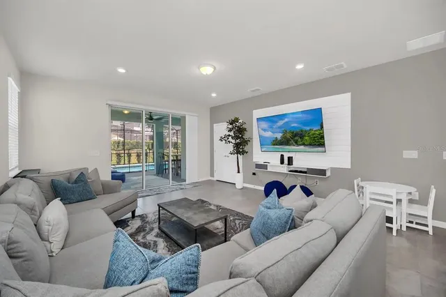 a living room with furniture and a flat screen tv