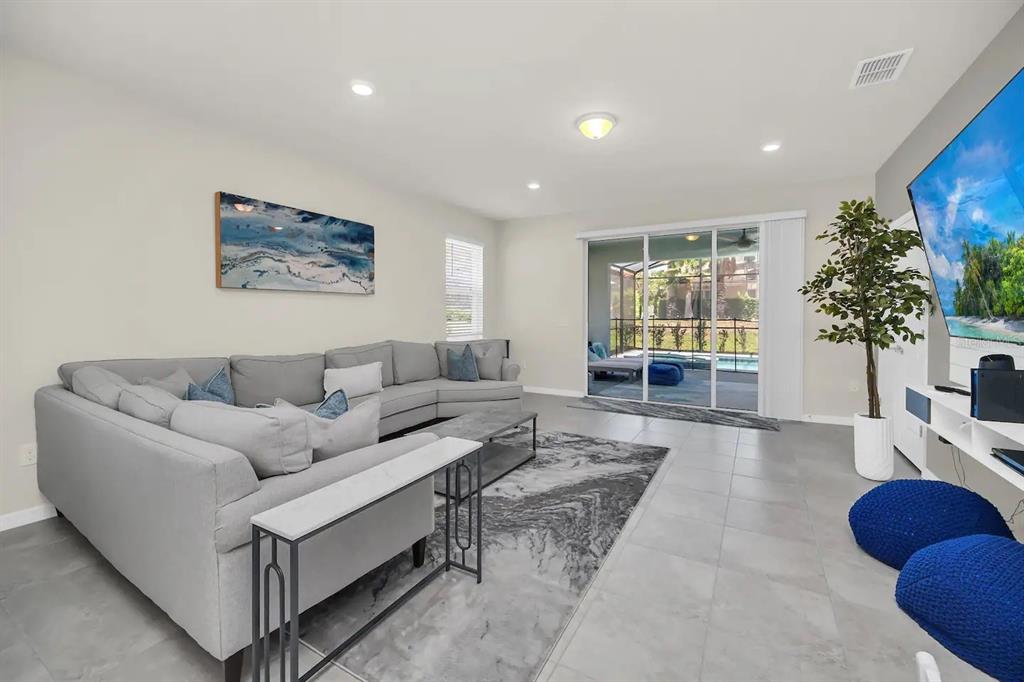 7263 Oakmoss Loop Davenport, FL 33837 - Photo 18 of 57 a living room with furniture potted plant and a window