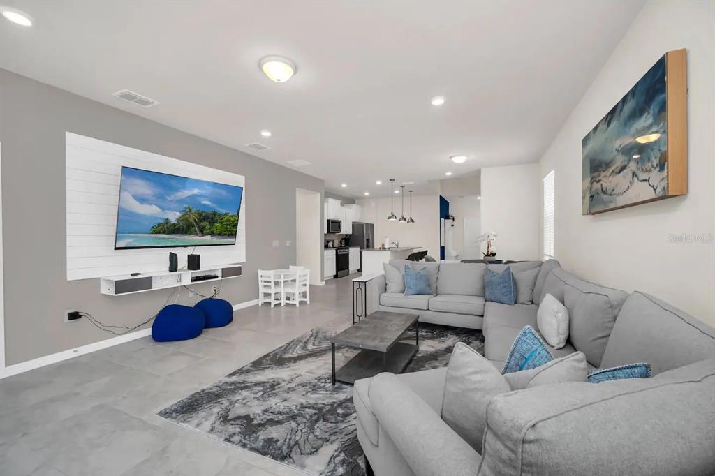 7263 Oakmoss Loop Davenport, FL 33837 - Photo 19 of 57 a living room with furniture and a flat screen tv