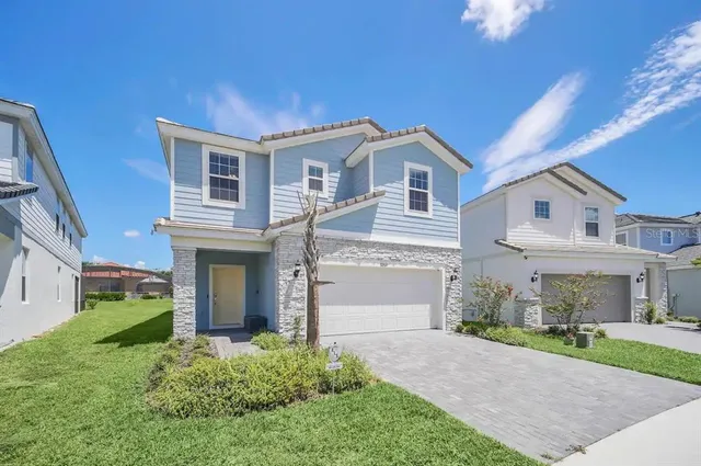 a front view of a house with a yard and garage