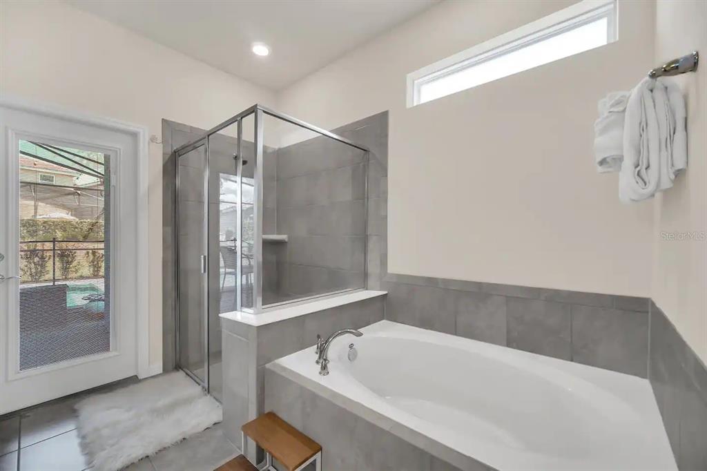 7263 Oakmoss Loop Davenport, FL 33837 - Photo 24 of 57 a bathroom with a tub a sink and a shower