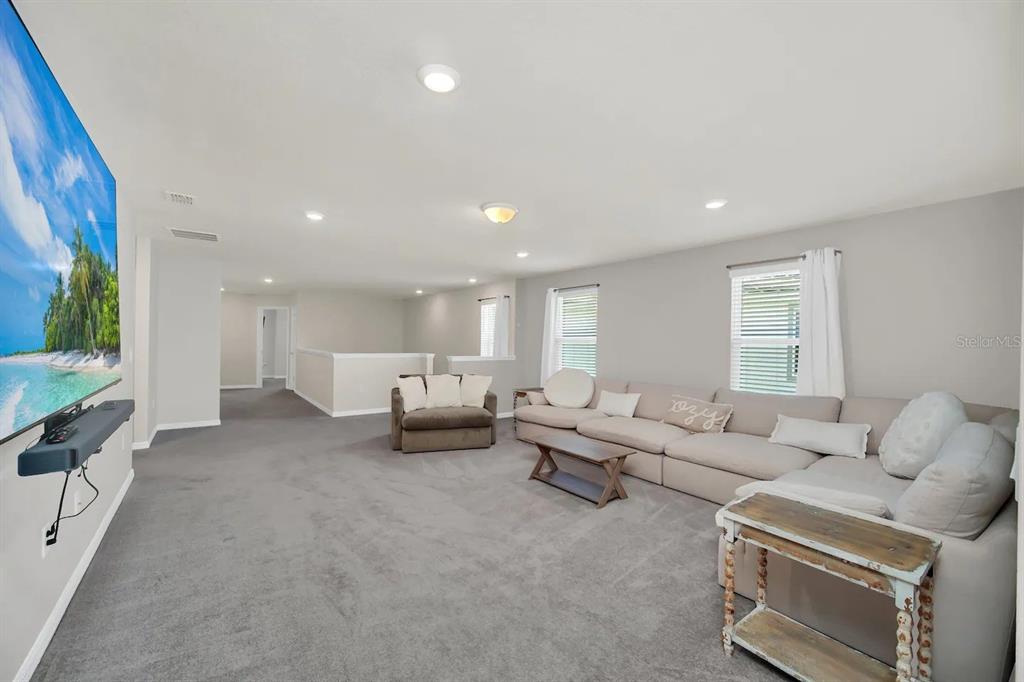 7263 Oakmoss Loop Davenport, FL 33837 - Photo 25 of 57 a living room with furniture and a large window