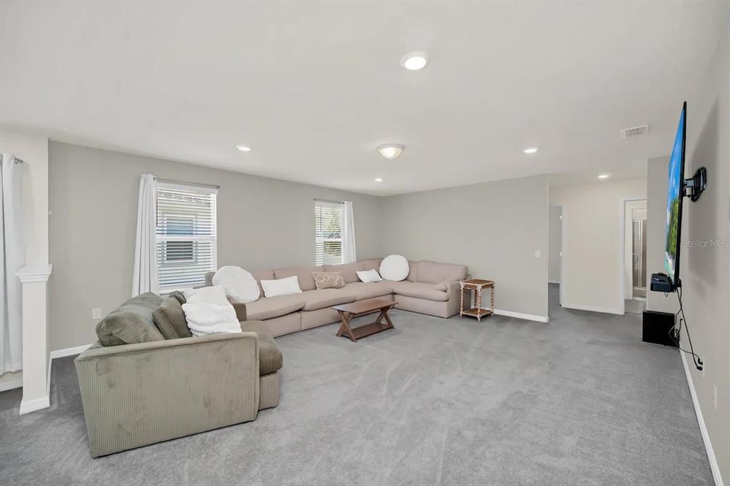 7263 Oakmoss Loop Davenport, FL 33837 - Photo 26 of 57 a living room with furniture and a window