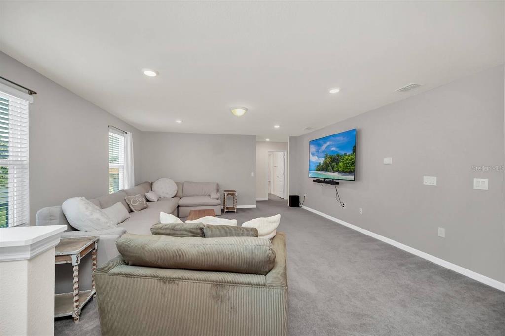 7263 Oakmoss Loop Davenport, FL 33837 - Photo 28 of 57 a living room with furniture and a flat screen tv