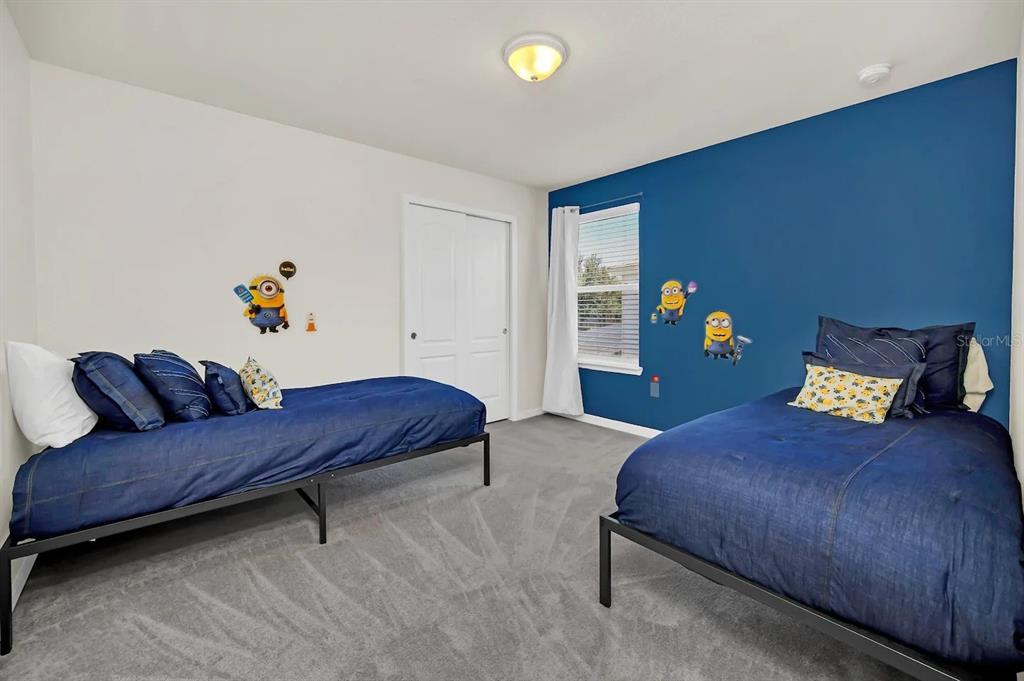 7263 Oakmoss Loop Davenport, FL 33837 - Photo 29 of 57 a bedroom with a bed and a couch