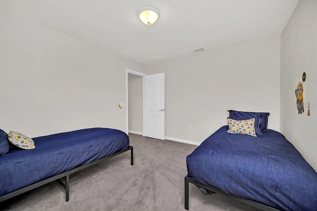 7263 Oakmoss Loop Davenport, FL 33837 - Photo 30 of 57 a bedroom with a bed and a dresser