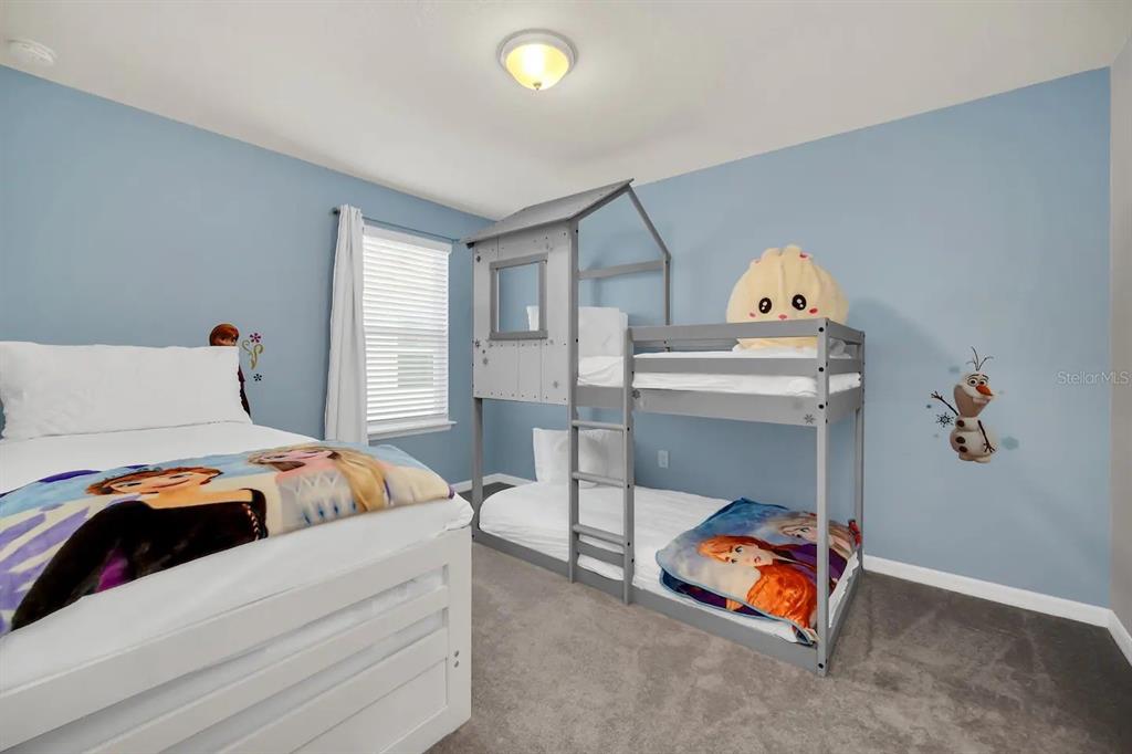 7263 Oakmoss Loop Davenport, FL 33837 - Photo 31 of 57 a bedroom with a bed and a window