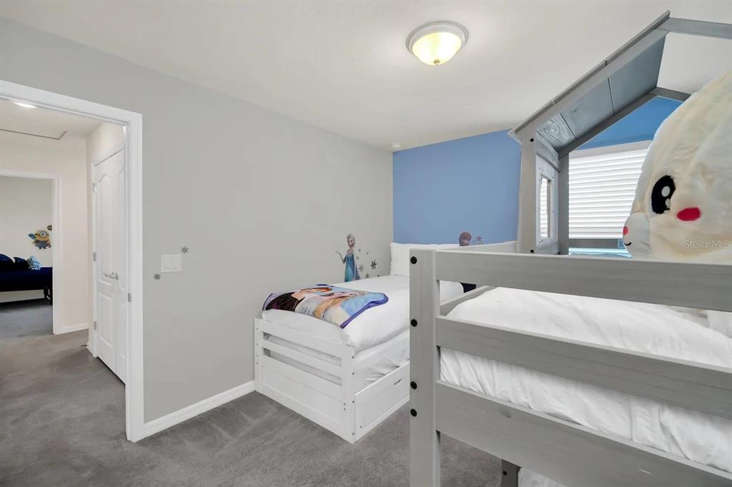 7263 Oakmoss Loop Davenport, FL 33837 - Photo 33 of 57 a bedroom with a bed and a couch