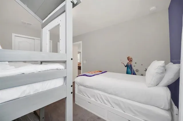 a spacious bedroom with a bed and a window