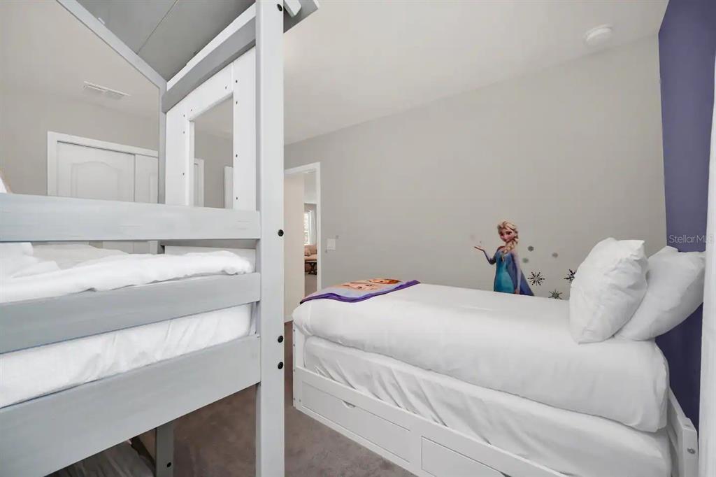 7263 Oakmoss Loop Davenport, FL 33837 - Photo 34 of 57 a bedroom with a bed and a window