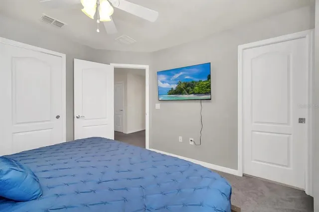 a bedroom with bed and cupboard