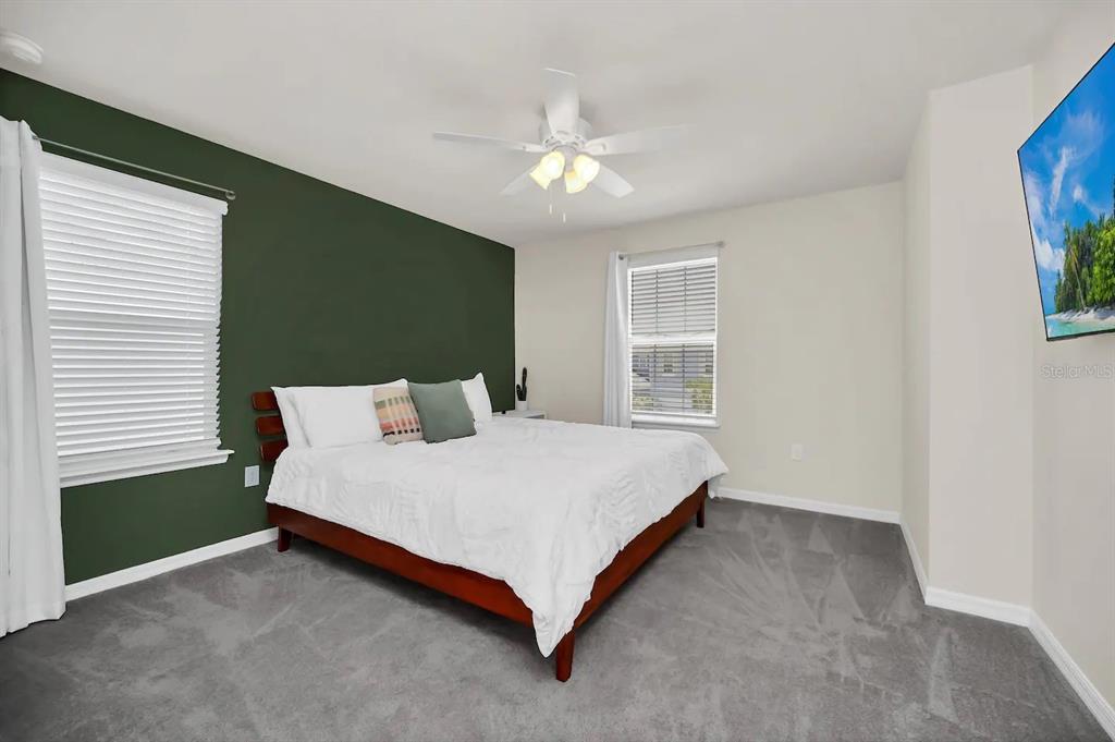 7263 Oakmoss Loop Davenport, FL 33837 - Photo 39 of 57 a spacious bedroom with a bed and a window