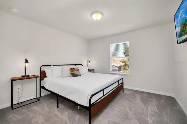 a living room with furniture and a floor to ceiling window