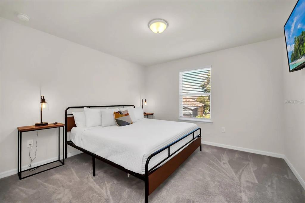 7263 Oakmoss Loop Davenport, FL 33837 - Photo 41 of 57 a bedroom with a bed and a window