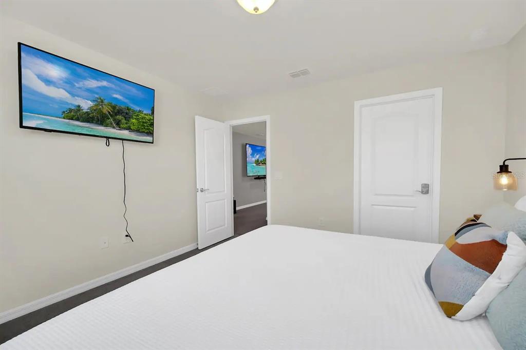 7263 Oakmoss Loop Davenport, FL 33837 - Photo 42 of 57 a bedroom with bed and cupboard