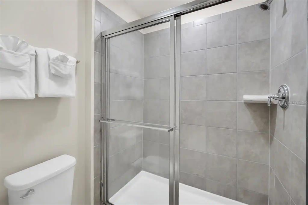 7263 Oakmoss Loop Davenport, FL 33837 - Photo 43 of 57 a bathroom with a shower and a toilet