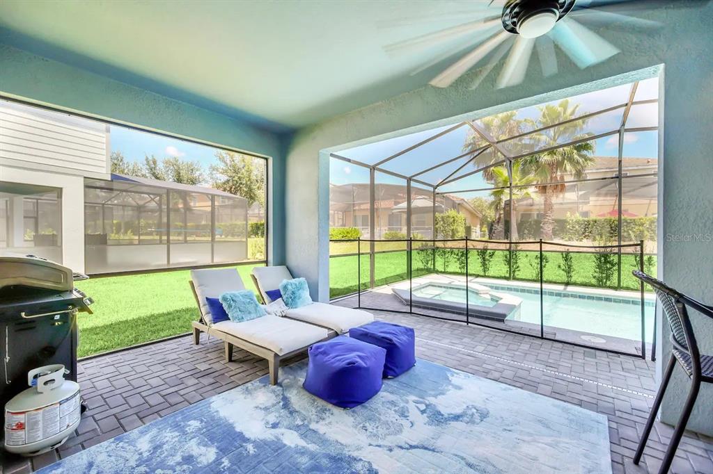 7263 Oakmoss Loop Davenport, FL 33837 - Photo 46 of 57 a living room with furniture and a floor to ceiling window