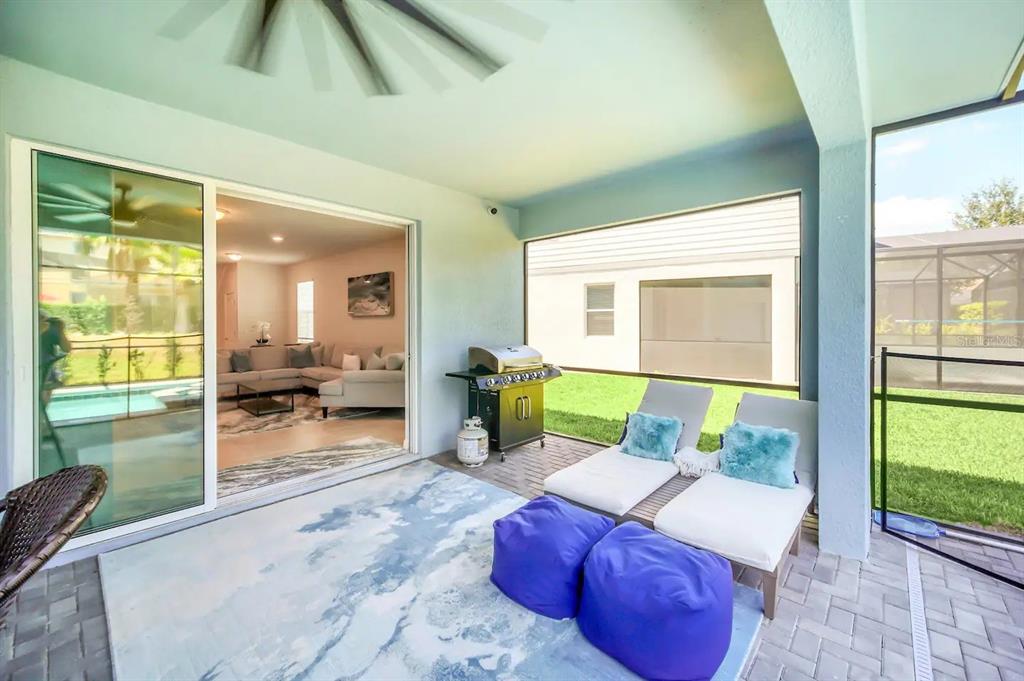 7263 Oakmoss Loop Davenport, FL 33837 - Photo 52 of 57 a living room with furniture floor to ceiling window and a floor