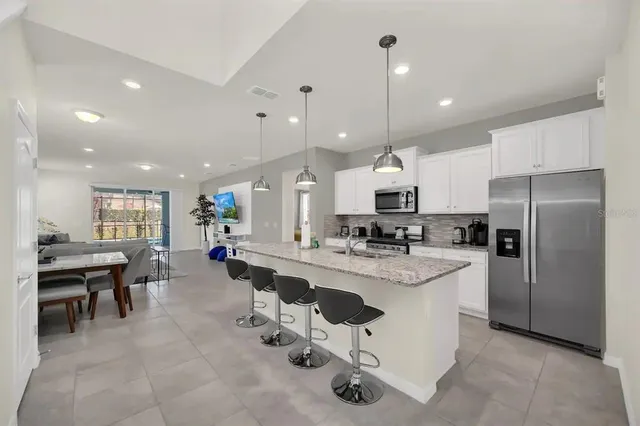 a kitchen with a stove a sink and a microwave