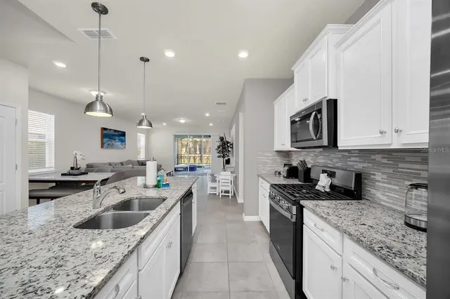 a living room with furniture a dining table and kitchen view