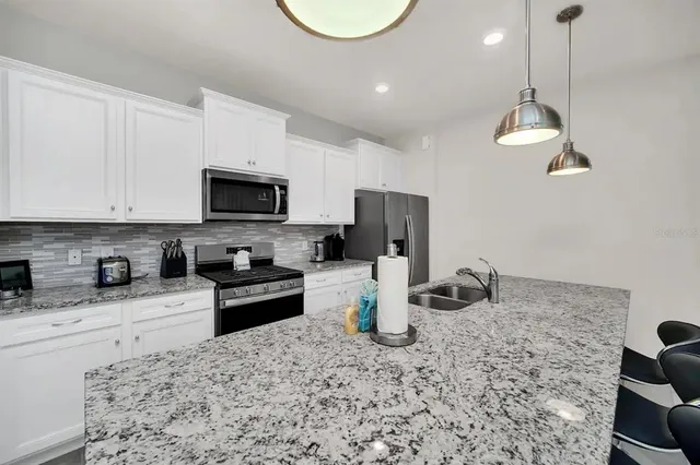 a living room with furniture a rug and a large window
