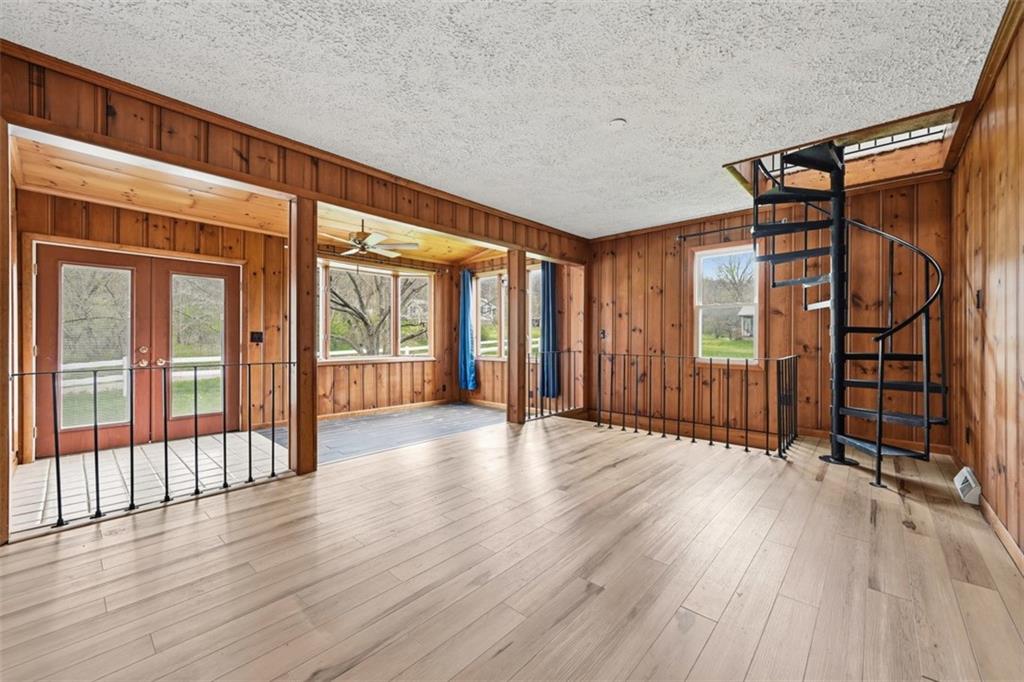 192 Yellow Creek Road Harmony, PA 16037 - Photo 12 of 41 wooden floor stairs and an empty room with wooden floor and windows