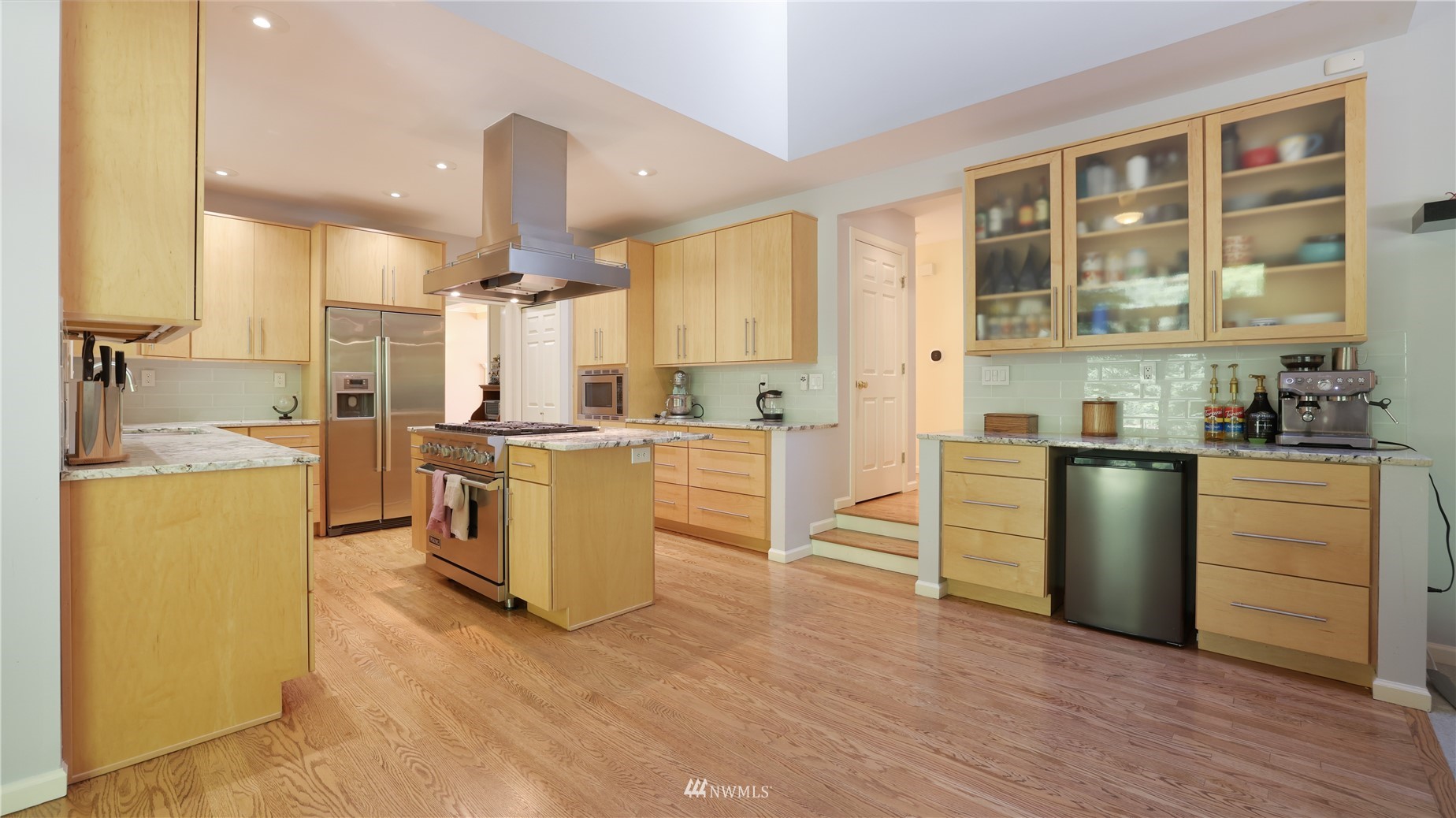 16038 Southeast 125th Street Renton, WA 98059 - Photo 15 of 34 a kitchen with kitchen island a counter top space a sink stainless steel appliances and cabinets