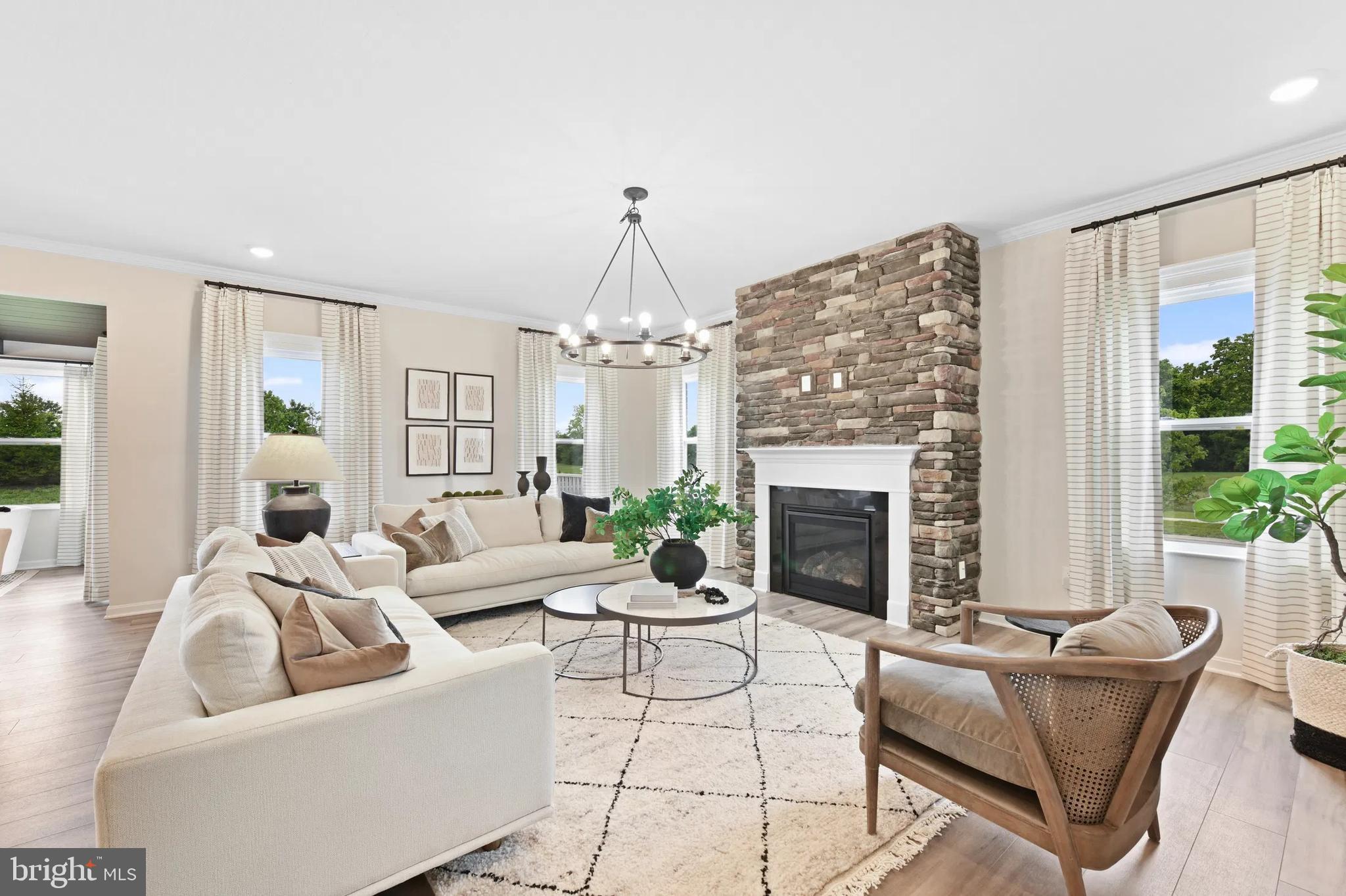 3 Bowens Run Road Bealeton, VA 22712 - Photo 5 of 14 a living room with furniture a fireplace and a chandelier